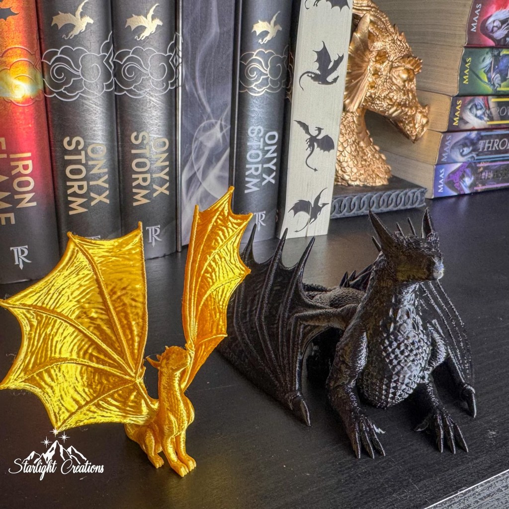 Tairn and Andarna dragon figurines from Fourth Wing