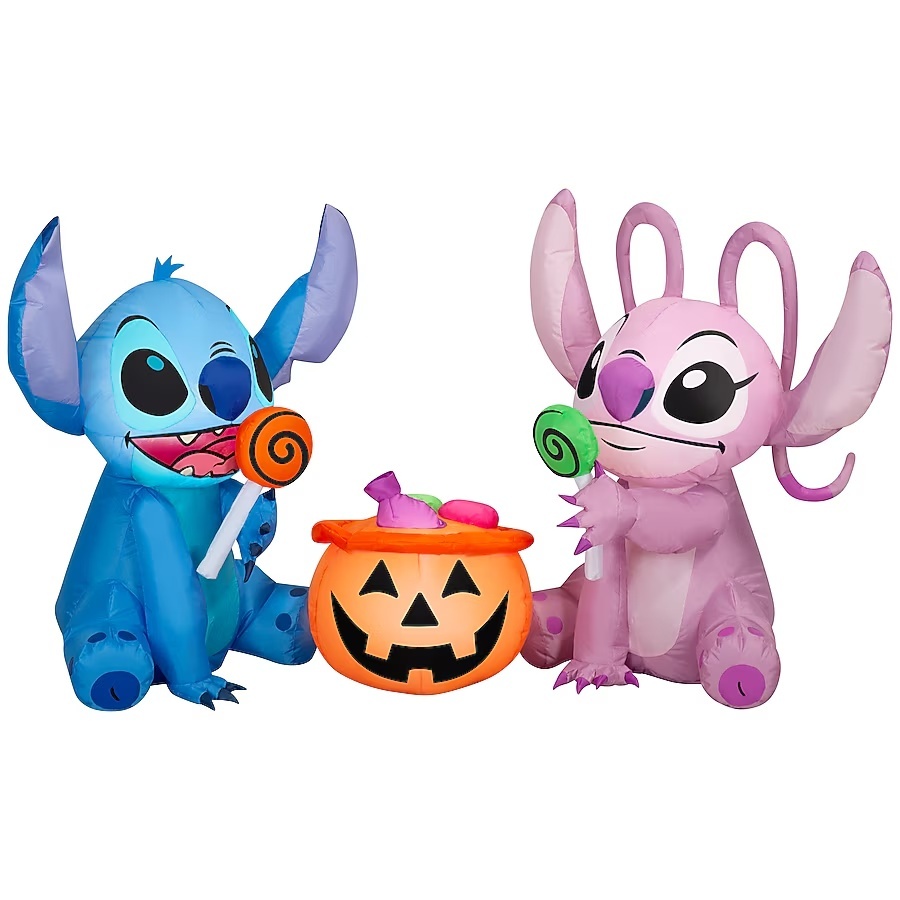 Stitch and Angel Halloween inflatable holding lollipops beside a jack-o'-lantern candy bucket